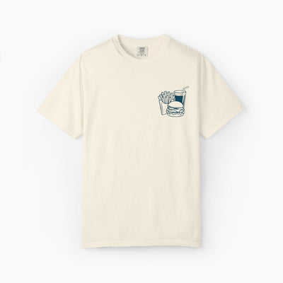 Beige t-shirt with a graphic of a burger, fries, and drink on a white background